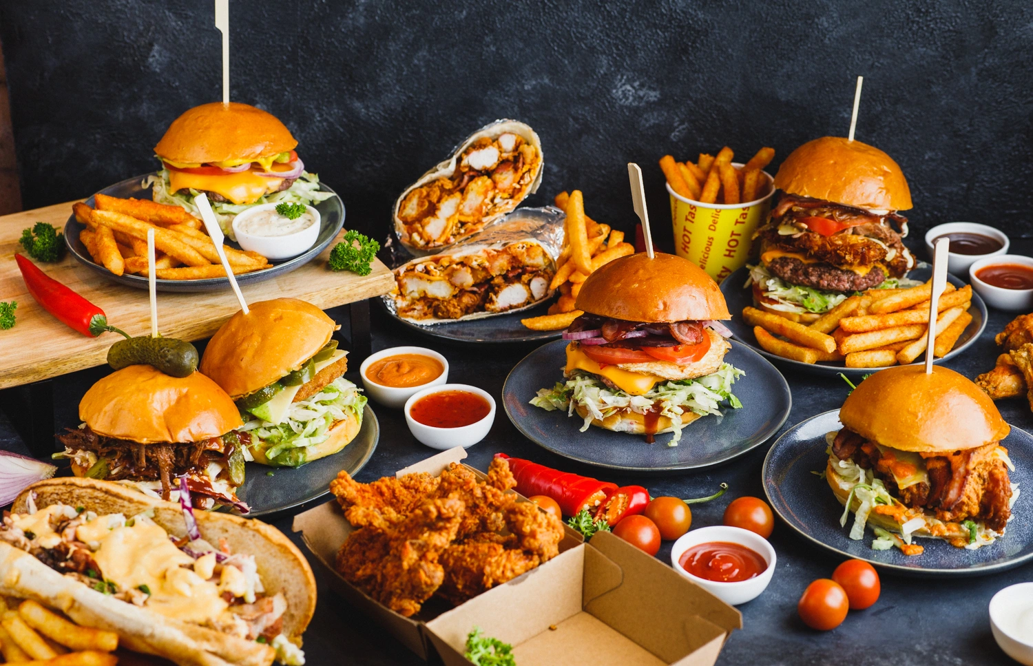 Full catering spread of burgers, wraps and wings